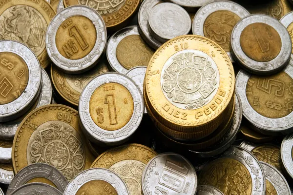 Ten Mexican Pesos Coin on a Pile of Coins