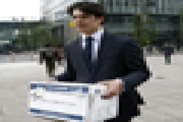 A Lehman Brothers employee carries a box away from the office of the U.S. investment bank in London