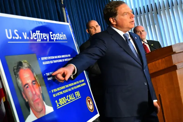 Geoffrey Berman, U.S. attorney for the Southern District of New York, speaks while standing next to a poster displaying the image of fund manager Jeffrey Epstein. (Louis Lanzano/Bloomberg)