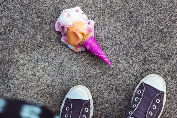 High angle view of ice cream fallen on footpath