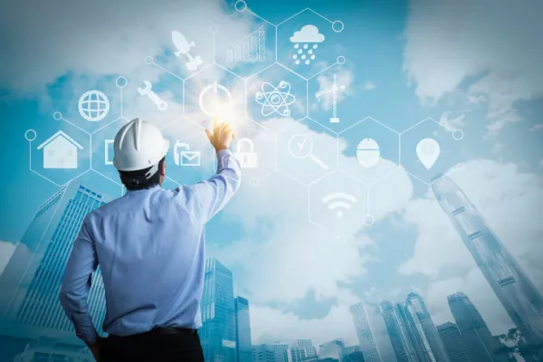 young engineer activating touch screen on blue background