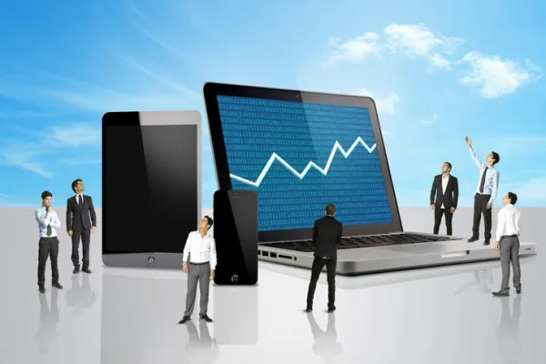 Group of men looking at a laptop with stocks mark