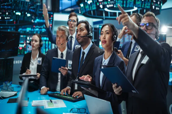 Diverse Stock Exchange Professionals Communicating in an Open Outcry Method on a Trading Floor. Men and Female Shouting and Using Hand Signals to Transfer Information About Buy and Sell Orders