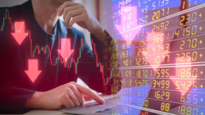 Investment financial property trading in down trend Businessman using computer working on virtual trading price and graph with arrow are pointing down