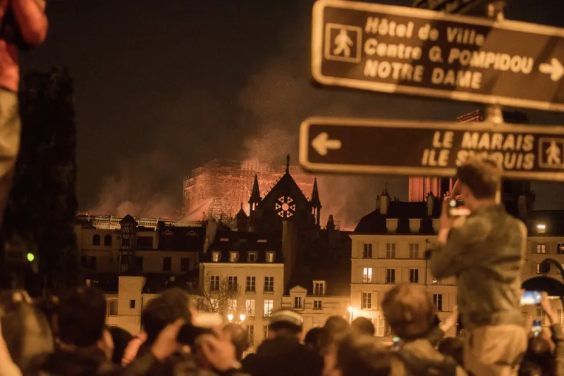 Watching the fire burn at Notre-Dame Cathedral in Paris. (Martin Barzilai/Bloomberg)