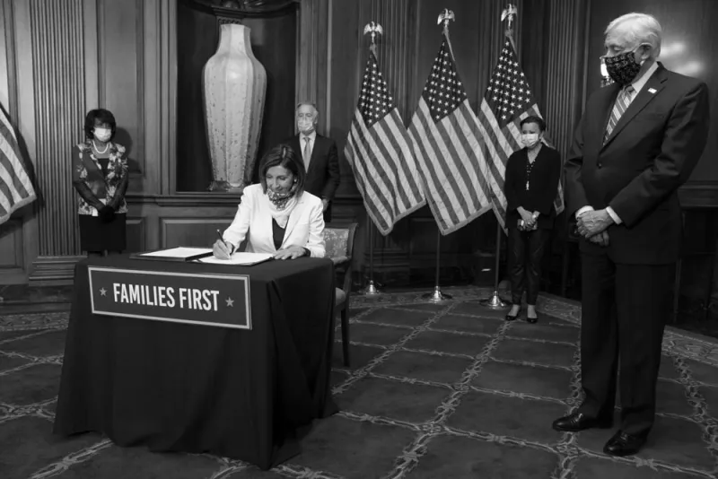 House Speaker Nancy Pelosi signs The Paycheck Protection Program and Health Care Enhancement Act in April. (Sarah Silbiger/Bloomberg)